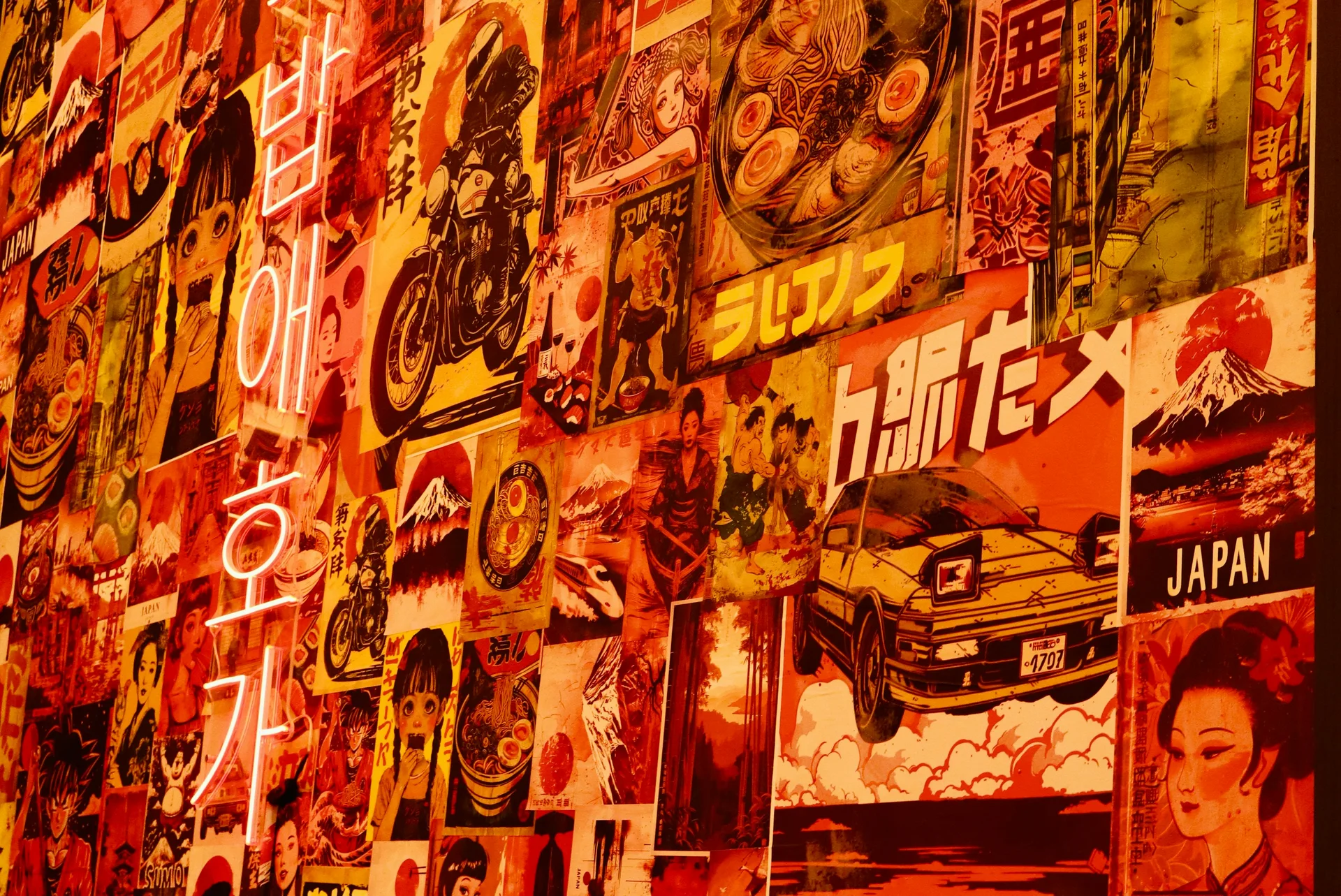 A wall of colourful printed posters and illuminated lettering.